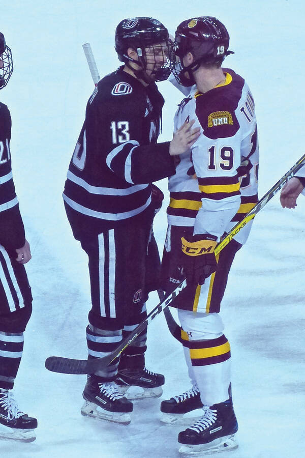 Former Duluth East line mates Jake Randolph, left, of UNO, and Dom Toninato of the Bulldogs met at center ice after UMD’s sweep. Photo credit: John Gilbert