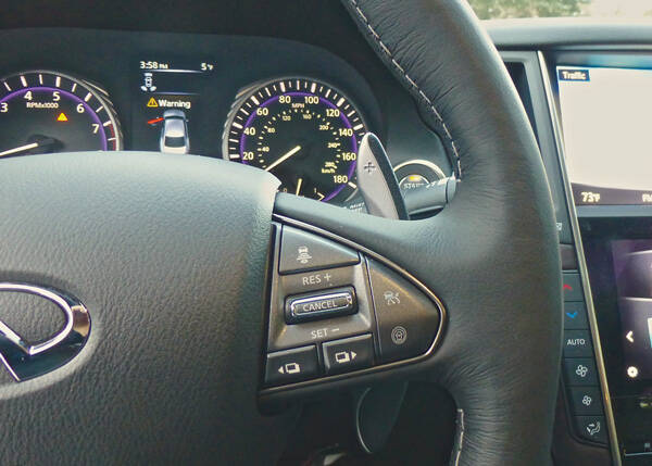 Steering wheel controls show a hint of the upshift paddle... Photo credit: John Gilbert
