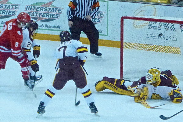 Miami freshman Gordie Green (9), who tied the game late in the third period, lifted a rebound over UMD goalie Hunter Miska in the second overtime of the second game in the series. Photo credit: John Gilbert