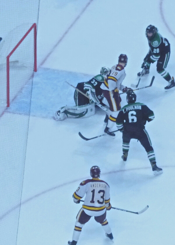 UMD's Joey Anderson (13) tried to pass rink-wide but the puck hit North Dakota defenseman Hayden Shaw and glanced through goalie Cam Johnson for the game-winning goal with 51 seconds remaining. Photo credit: John Gilbert