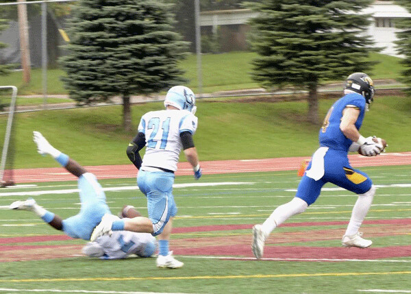 St. Scholastica’s Aaron Olson ran away from Westminster defenders on his way to a 90-yard touchdown play in the Saints 48-18 victory. Photo credit: John Gilbert