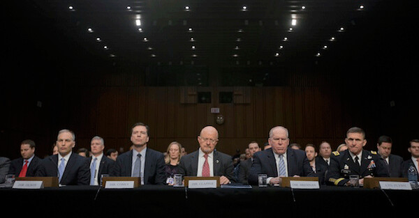   Director of National Intelligence James Clapper, center, and other officials testify on Capitol Hill last month at a Senate Intelligence Committee hearing on national security threats. From left: National Counterterrorism Center Director Matthew Olsen, FBI Director James Comey, Clapper, CIA Director John Brennan and Defense Intelligence Agency Director Lt. Gen. Michael Flynn. (AP/Pablo Martinez Monsivais)