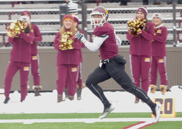 UMD receiver Jason Balts looks around as if he can't believe he's so alone -- except for UMD's warmly dressed danceline… Photo credit: John Gilbert