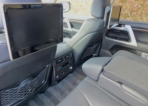 Fold-down console for backseat buckets leaves comfortable access to huge video screens.Photo credit: John Gilbert