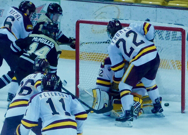 Western Michigan's Jade McMullen (14) smacked a loose puck into the UMD goal to complete a 5-0 victory. Photo credit: John Gilbert