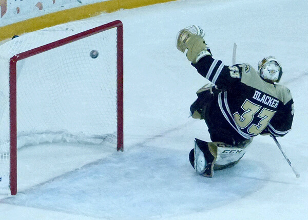 Western Michigan sophomore goalie Ben Blacker turned gymnast but UMD's shot from the right hit the left post and ricocheted right back out. Photo credit: John Gilbert
