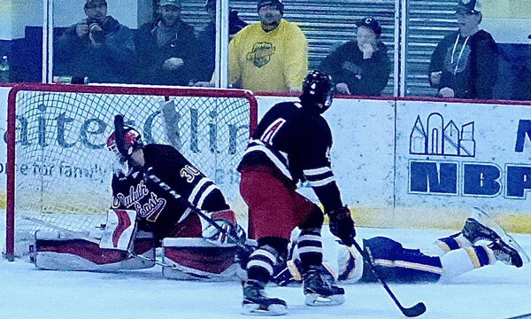 Kade Bender slid pass the Duluth East goal after scoring against goalie Lukan Hanson to lift Cloquet into a 5-5 tie with 3:05 remaining in the third period of the eventual 6-6 tie. Photo credit: John Gilbert