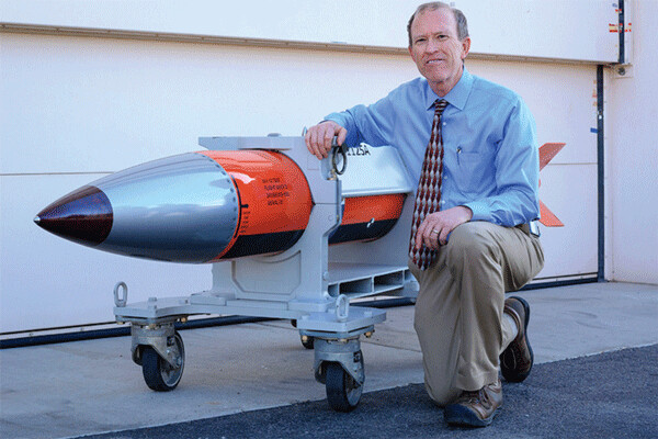 Phil Hoover, an engineer at Sandia National Laboratories, in New Mexico poses with a flight test body for a B61-12 nuclear weapon which may be the US’s first “guided” gravity-drop H-bomb. Energy Dept. photo.