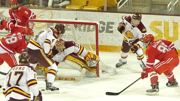 UMD goaltender Hunter Shepard spotted a loose puck and covered it to protect his 34-save 3-0 shutout Saturday. Photo credit: John Gilbert