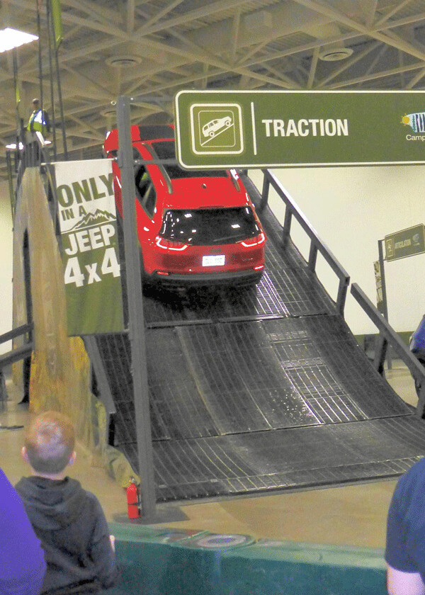 A young lad with his parents at the Twin Cities Auto Show gazed as a Jeep vehicle at Camp Jeep scaled a steep man-made hill. The show runs through March 18. Photo credit: John Gilbert