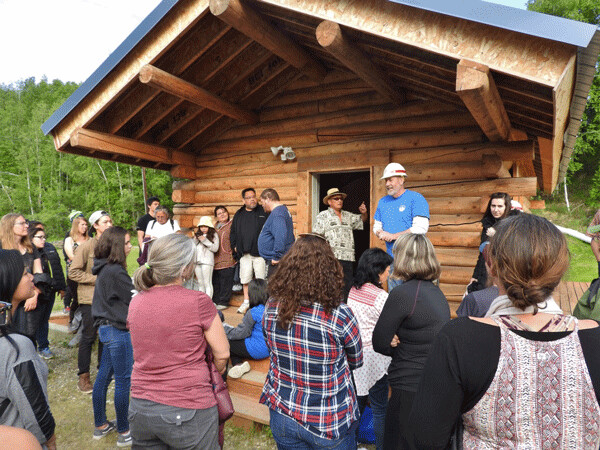Participants in the Climate Change and My Community workshop gather for a safety talk before entering the US Army Corps of Engineers Permafrost Tunnel Research Facility. Photo by Emily Stone.
