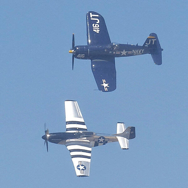 Among the vintage planes on display, a Navy Corsair and Air Force P-51 Mustang flew together.  Photo credit: John Gilbert
