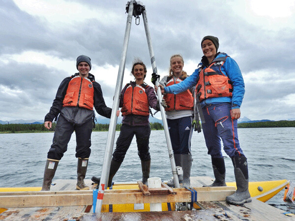 This crew of female scientists has spent the past few weeks taking samples of lake bottom sediments in Alaska. Here they stand on their custom-made coring raft. From left to right:  Abby Boak, Ellie Broadman, Emmy Wrobleski, and Annie Wong. Photo by Emily Stone.