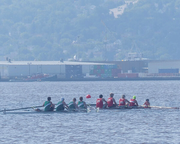 With Duluth’s skyline in the background, the Minneapolis Rowing Club had a close battle before winning the Men’s 4 final, one of its eight victories. Photo credit: John Gilbert