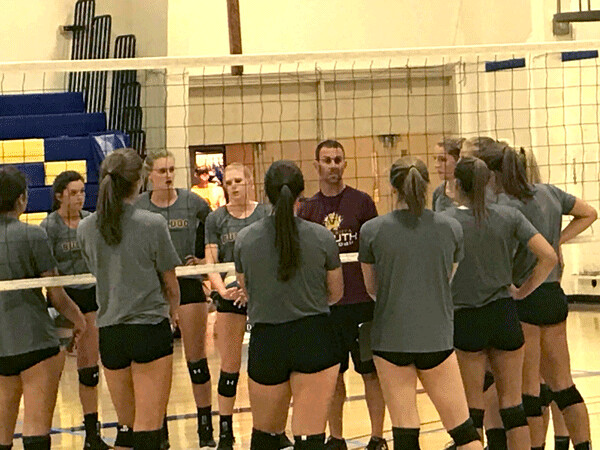 UMD volleyball coach Jim Boos advised his players on technique drill at first practice.  Photo credit: John Gilbert