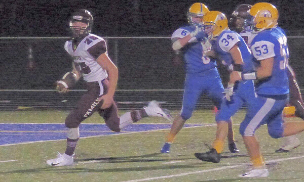 Two Harbors senior Joey Marker burst through the Esko defense for his second touchdown, clinching a 19-12 victory. Photo credit: John Gilbert