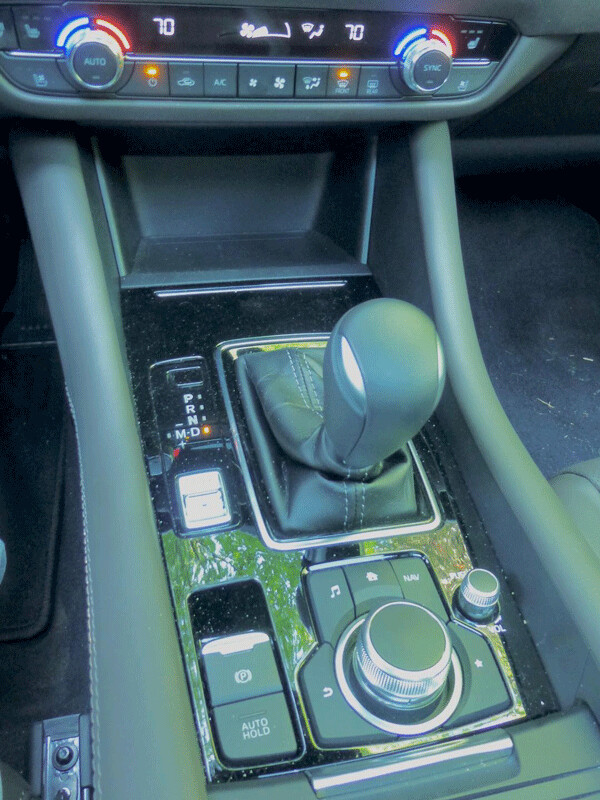 Console shifter is joined by knob controlling what feature will appear on touch-screen, and  sport setting toggle is at left. Photo credit: John Gilbert