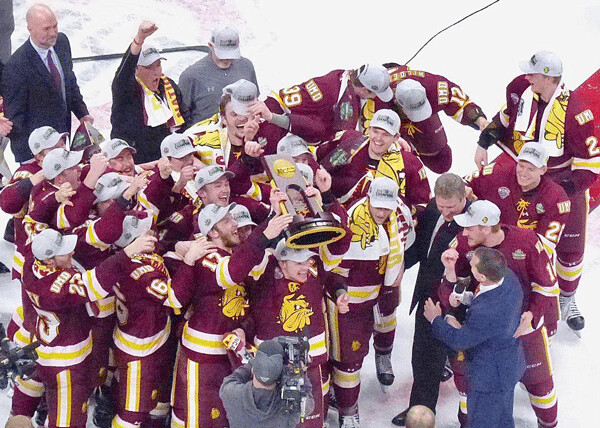 The happy band of Bulldogs hefted the NCAA championship trophy at Xcel Center in St. Paul last spring. Photo credit: John Gilbert
