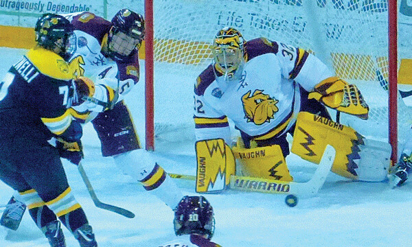 UMD goalie Hunter Shepard made the save, and defenseman Nick Wolff made sure Colorado College’s Alex Berardinelli didn’t get the rebound in Saturday’s game. Shepard was named NCHC goalie of the week, and Wolff the defensive player of the week. Photo credit: John Gilbert