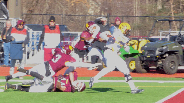 Texas A&M-Commerce's Ovie Urevbu finished a 15-yard run for the first touchdown, as UMD's Bill Atkins (3), Gus Wedig, and Michael Kirkendoll failed to bring him down. Photo credit: John Gilbert