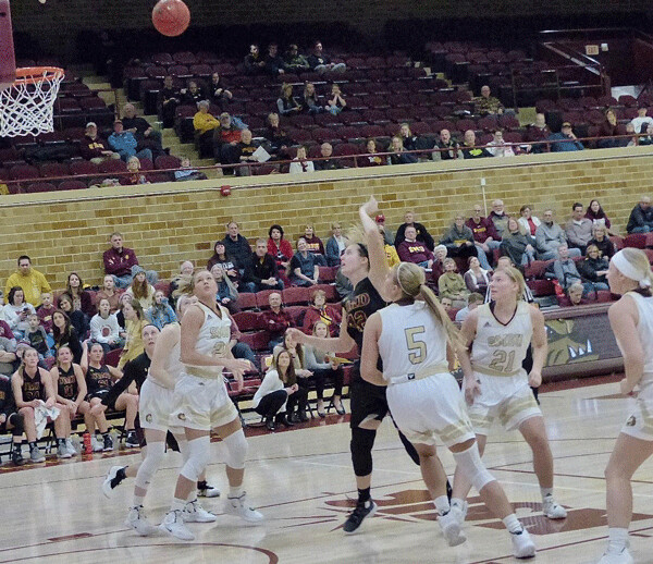 UMD standout Sarah Grow wasn't fazed by being surrounded by all five Southwest State players as she scored two of her 20 points in UMD's 60-39 victory. Photo credit: John Gilbert
