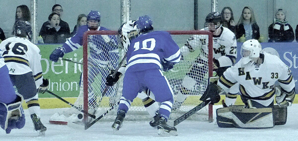 Hermantown goaltender Cole Manahan came up with the save on Minnetonka's Hunter Newhouse, who scored two goals in the game. Photo credit: John Gilbert