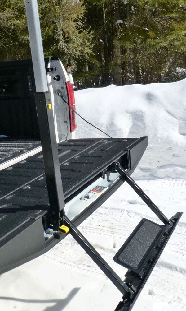 Ford’s clever drop down step out of the tailgate, complete with grab rod, which  deploy with mechanical buttons. Photo credit: John Gilbert