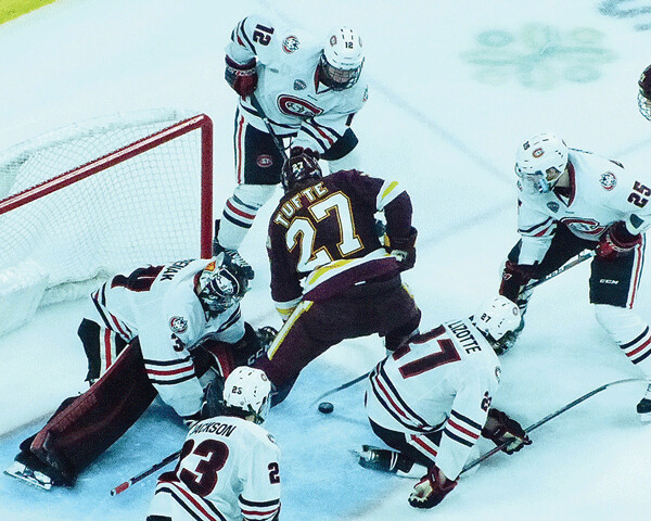 Riley Tufte went after the puck in the crease against St. Cloud State in UMD's 3-2, double-overtime victory. Photo credit: John Gilbert