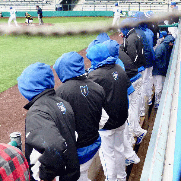 Hoodies were part of St. Scholastica’s uniforms Tuesday against 34 degree game  temperature Tuesday at Wade Stadium. Photo credit: John Gilbert