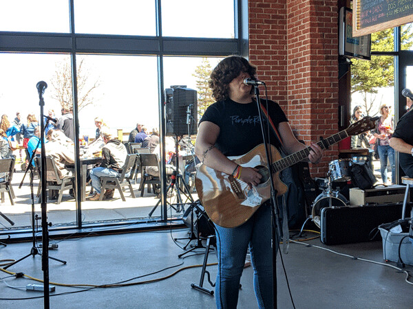 Hannah Rey at Canal Park Brewing Company on Brunch & Recovery Day. Rey  captivated the audience with heartfelt poetic lyrics musically interwoven with her  guitar. Photo by Felicity Bosk
