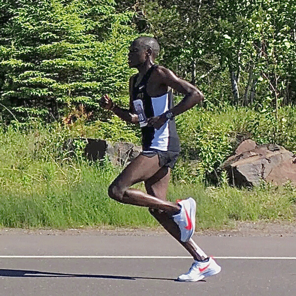 Boniface Kongin, an unknown runner from Kenya, ran all alone at a sizzling pace as Highway 61 reached Lester River, and despite leg problems that slowed him over the last seven miles, he won the 43rd Grandma's Marathon. Photos by Joan Gilbert