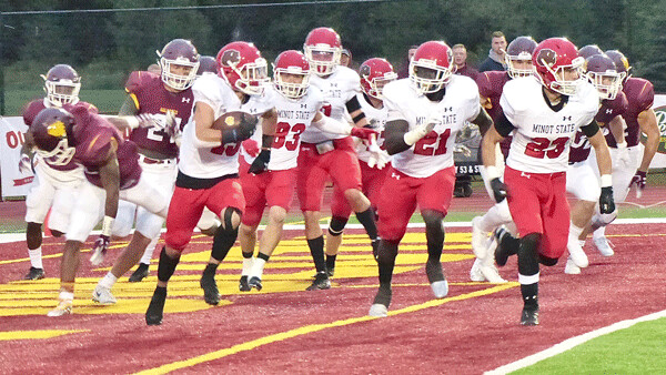 Minot State freshman Cory Carignan somehow escaped eight Bulldogs after recovering his own fumbled kickoff in the end zone, and... Photo credit: John Gilbert