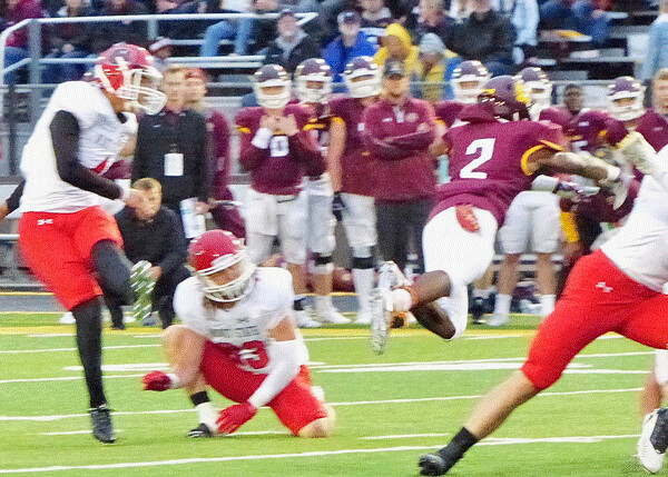 UMD's Justic'e King (2) made a flying block of Minot State's JoseLuis Moreno field goal attempt, to inspire UMD's second touchdown. Photo credit: John Gilbert