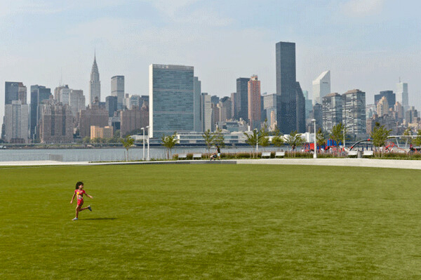 One especially climate-resilient feature of NYC's new Hunter's Point South Park is a big playfield made of synthetic turf that can “detain” a half million gallons of water when the East River overflows during a high tide or storm surge. Credit: NYC Parks.