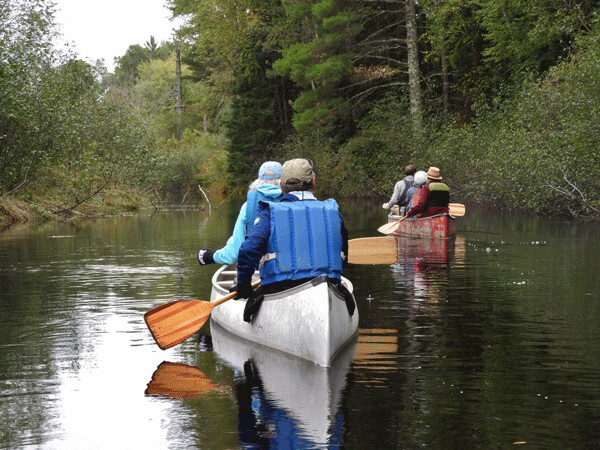 Canoeists slip silently down the West Fork of the Chippewa River. Photo by Emily Stone.