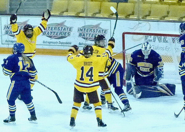 Gabbie Hughes, left, who scored the second UMD goal in Game 1, was first to spot Sydney Brodt's shot going in for the overtime game-winner in the 3-2 Game 1 victory. Anna Klein, the third member of the line, waited for the second game to score and ignite a 4-1 victory. Photo credit: John Gilbert