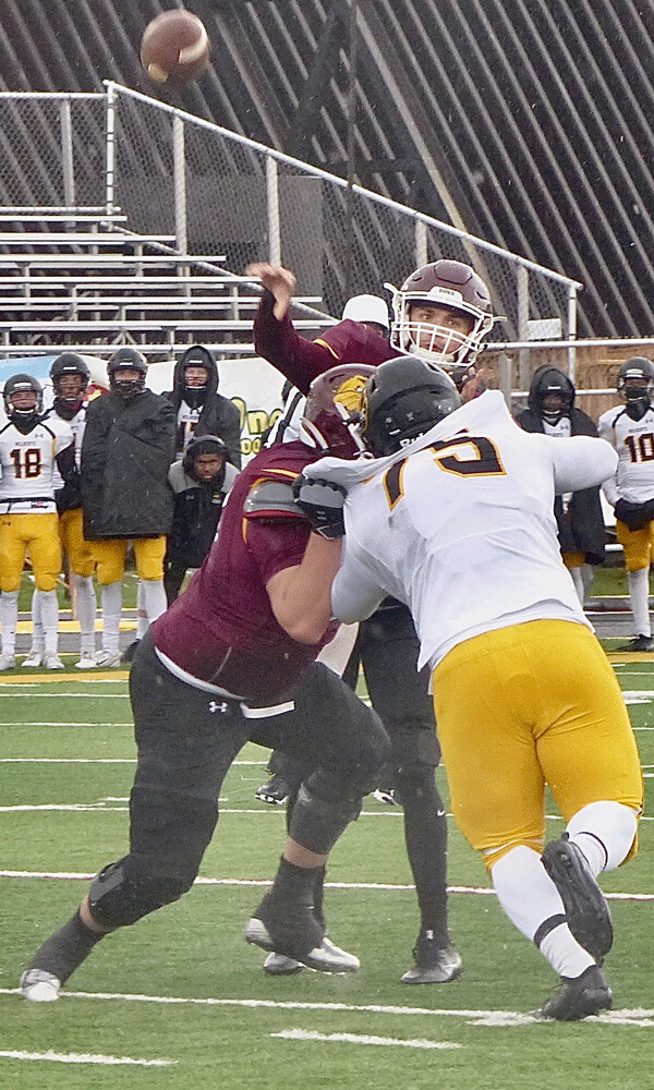 Alternating UMD quarterback Garrett OIson pitched the ball over the Wayne State defense for the end zone... Photo credit: John Gilbert