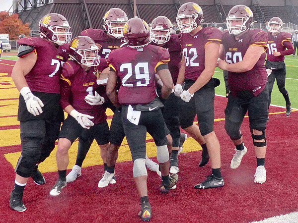  ...Freshman Byron Bynum (29) accepted the accolades of his teammates after catching Olson's pass for the go-ahead touchdown in UMD's 21-7 homecoming victory. Photo credit: John Gilbert