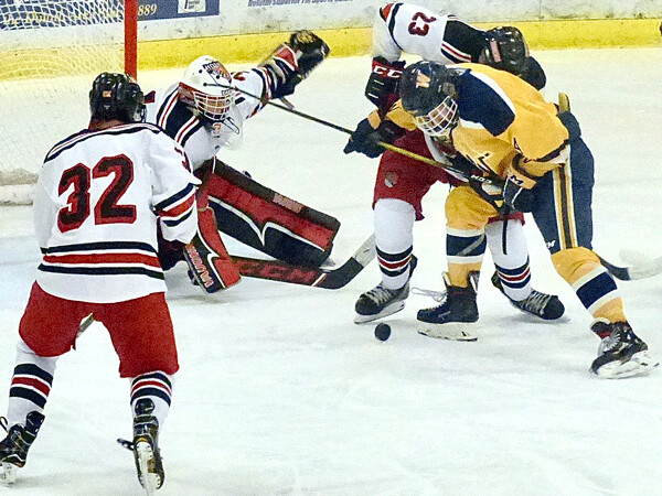 East goalie Konrad Kausch has shown a flair in rough early going, as Michael Sutherland (23) and Brady Gray help out against Wayzata. Photo credit: John Gilbert
