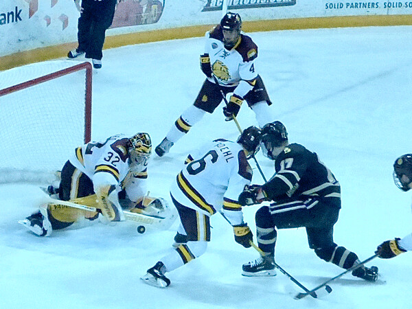UMD goaltender Hunter Shepard covered a rebound as Louie Roehl and Dylan Samberg kept Western Michigan's Wade Allison from getting to the crease. Photo credit: John Gilb