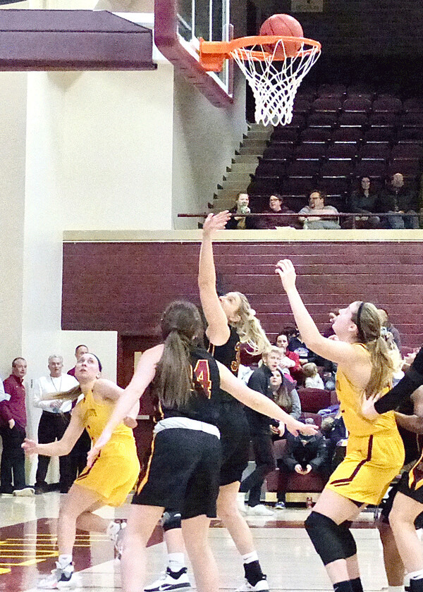 UMD's women finished undefeated at home, clinching the NSIC title with Friday's 65-54 victory over Northern State, as Taylor Schneider (left) scored with a layup. Photo credit: John Gilbert
