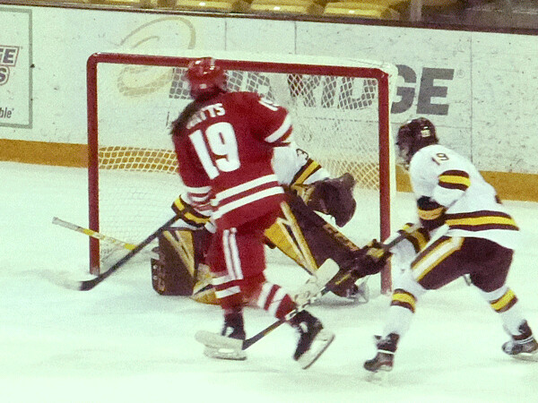 Daryl Watts broke in to beat Maddie Rooney in the second overtime, giving her 2 goals and 3 assists in Wisconsin 6-5 comeback victory over UMD.  Photo credit: John Gilbert