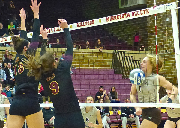 UMD’s tandem block by Allison Olley, left, and Sarah Kelly proved a good defense can be the best offense against Southwest’s Taylor Reiss. Photo credit: John Gilbert