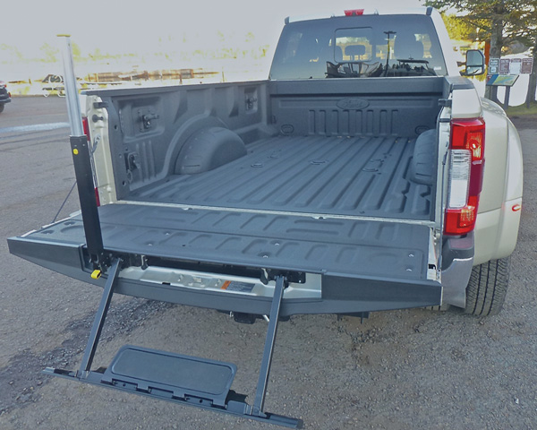 Highly useful fold-down step with upright support aids getting up and down from huge bed with its factory bedliner. Photo credit: John Gilbert