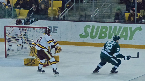 Bemidji freshman Zach Whitecloud peeled off to the right after scoring on UMD goalie Hunter Miska at 0:59 of the second overtime Friday night at AMSOIL Arena. Photo credit: John Gilbert