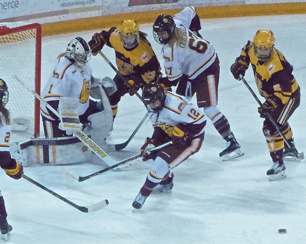 Top Gopher scorer Hannah Brandt (22) celebrated Milica McMillen’s goal in the 7-3 first-game against UMD.. Photo Credit: John Gilbert