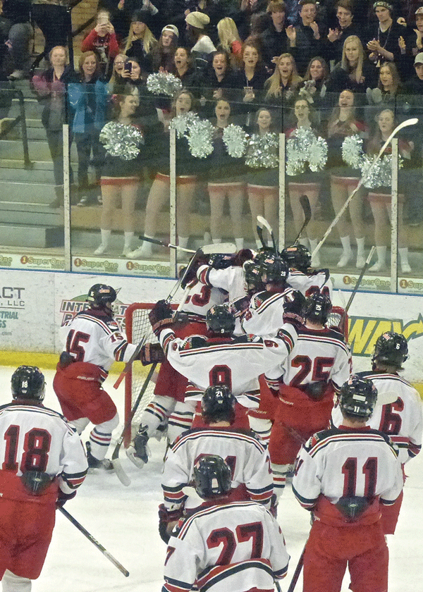 The Greyhounds streamed off the bench to surround goalie Kirk Meierhoff in a celebration that looked a lot like relief at avoiding the 7AA upset. Photo credit: John Gilbert