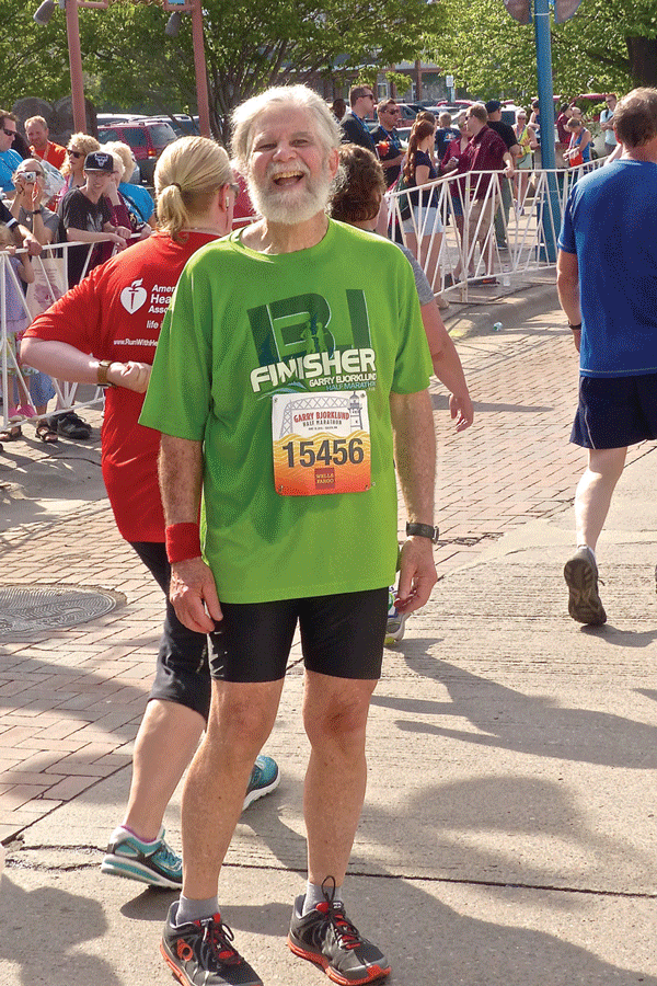 A smiling Benjie Wolfe completed his 18th Garry Bjorklund Half-Marathon, looking more fit than when he was a crowd favorite defenseman for UMD's hockey teams of the mid 1960s. Photo credit: John Gilbert