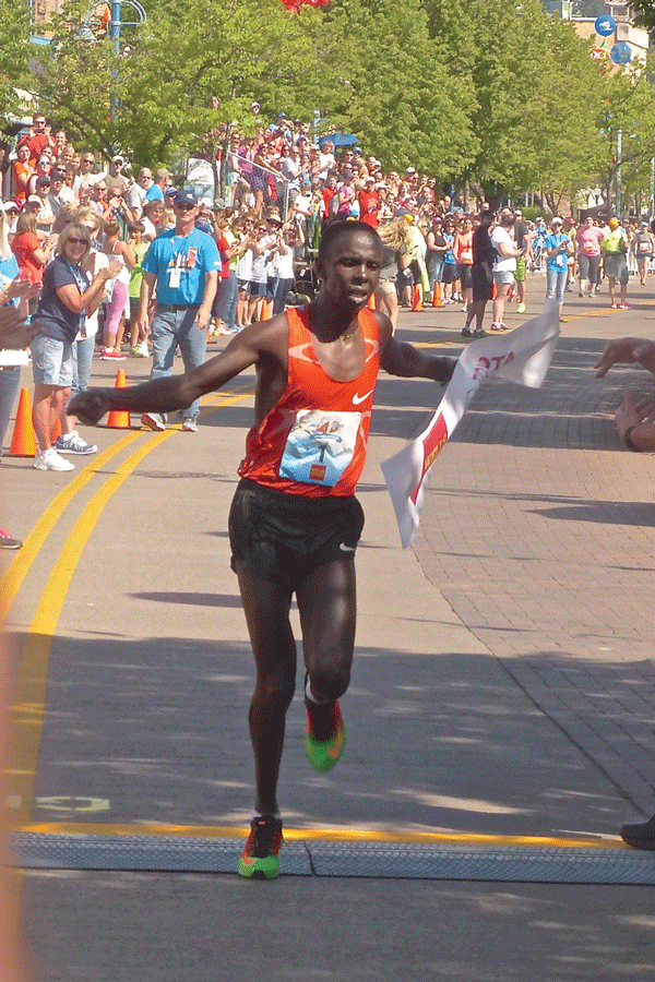 Elisha Barno, from Eldoret, Kenya, broke the tape to win his second straight Grandma’s Marathon in his second try. Photo credit: John Gilbert