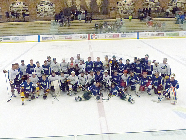 The two teams of current and former high school, junior, college and pro players gathered after the game for a joint team picture. Photo credit: John Gilbert